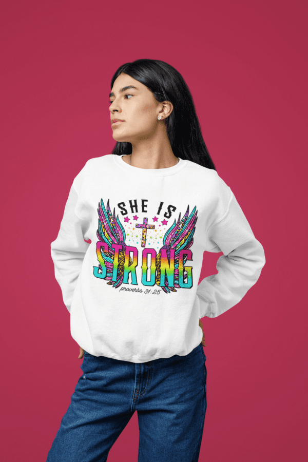 A woman wearing a sweatshirt that says She Is Strong.